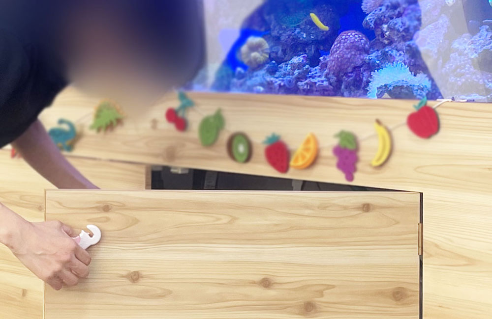 A Tokyo Aqua Garden technician servicing a client aquarium
